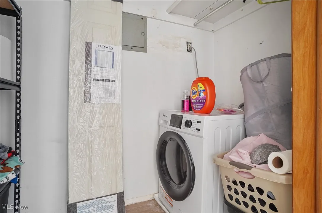 Laundry area with washer / clothes dryer and electric panel