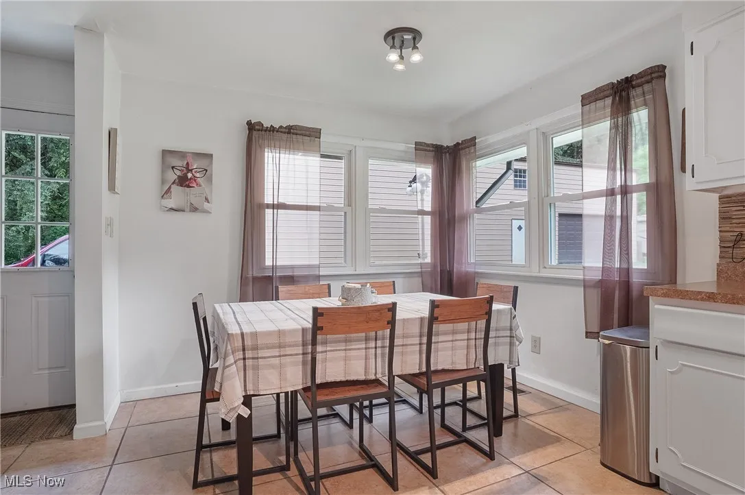 Dining area featuring light tile patterned floors and plenty of natural light