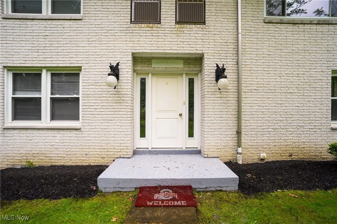 Doorway to property with brick siding