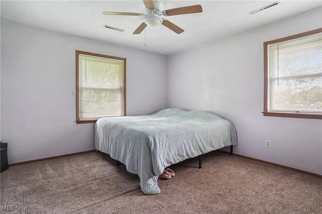 Bedroom with carpet and a ceiling fan