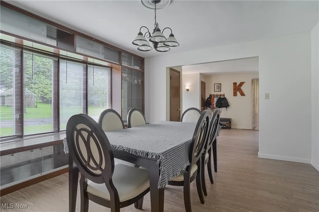 Dining room featuring light wood-style flooring and a chandelier