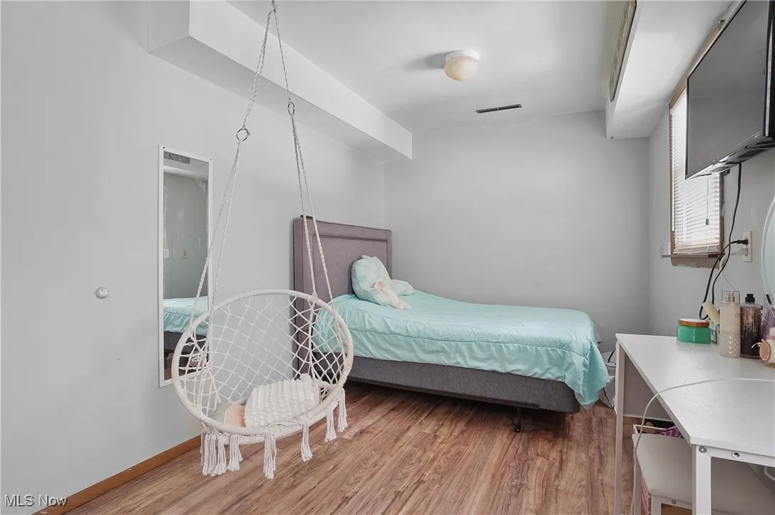Bedroom featuring wood finished floors and baseboards
