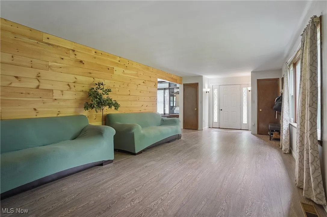 Living room featuring wood walls and wood finished floors