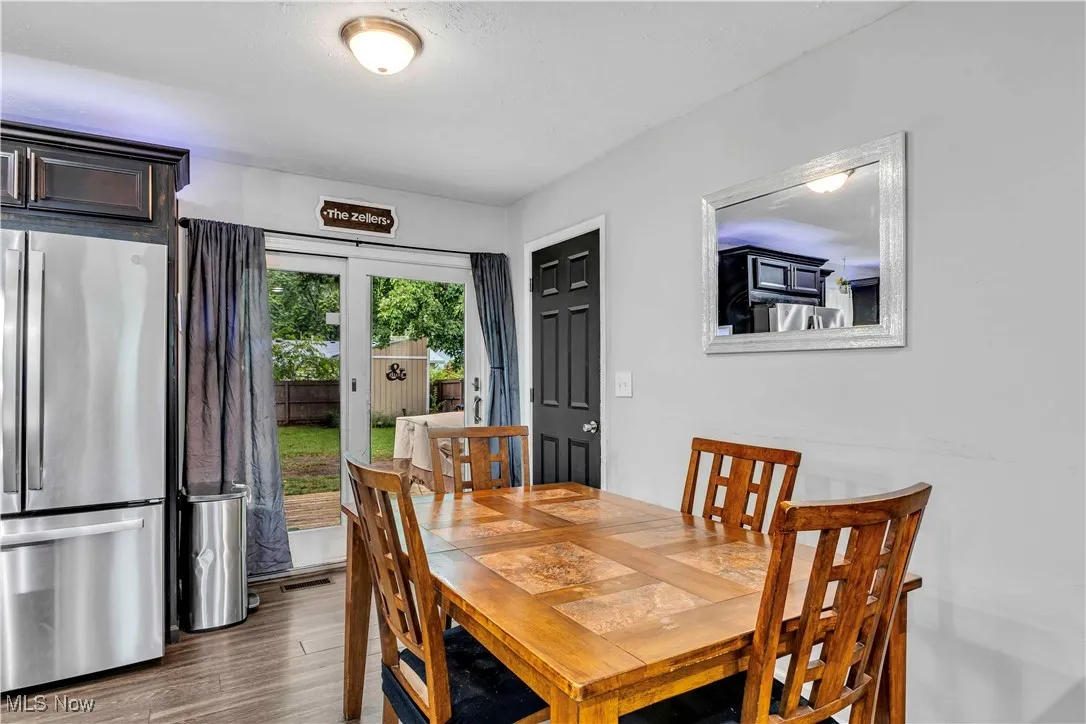 Dining area with dark wood-type flooring