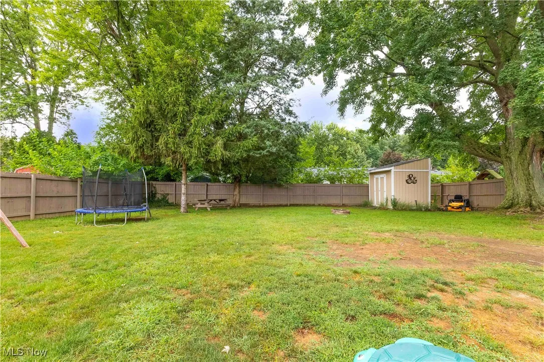 Expansive backyard featuring wood, privacy fence and shed.