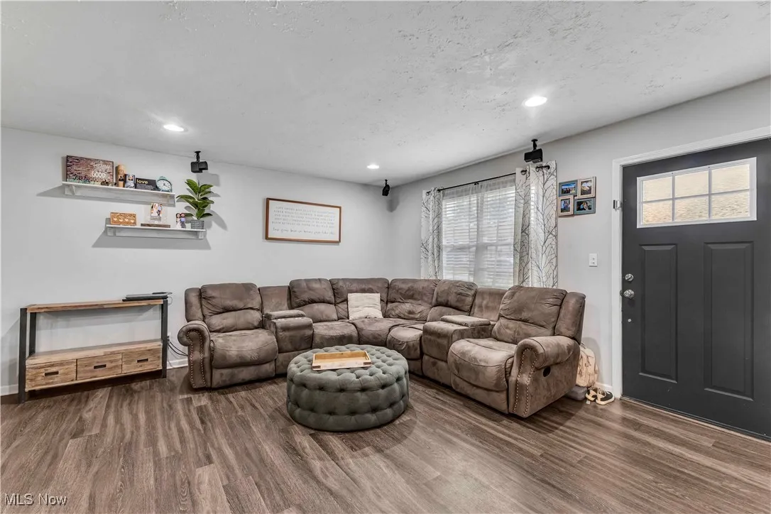 Living area featuring wood finished floors, recessed lighting, and a textured ceiling