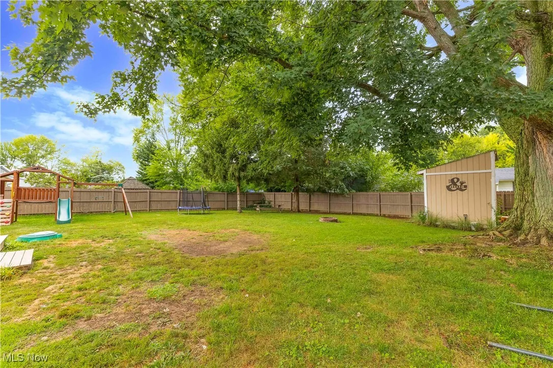 Expansive backyard featuring wood, privacy fence and shed.