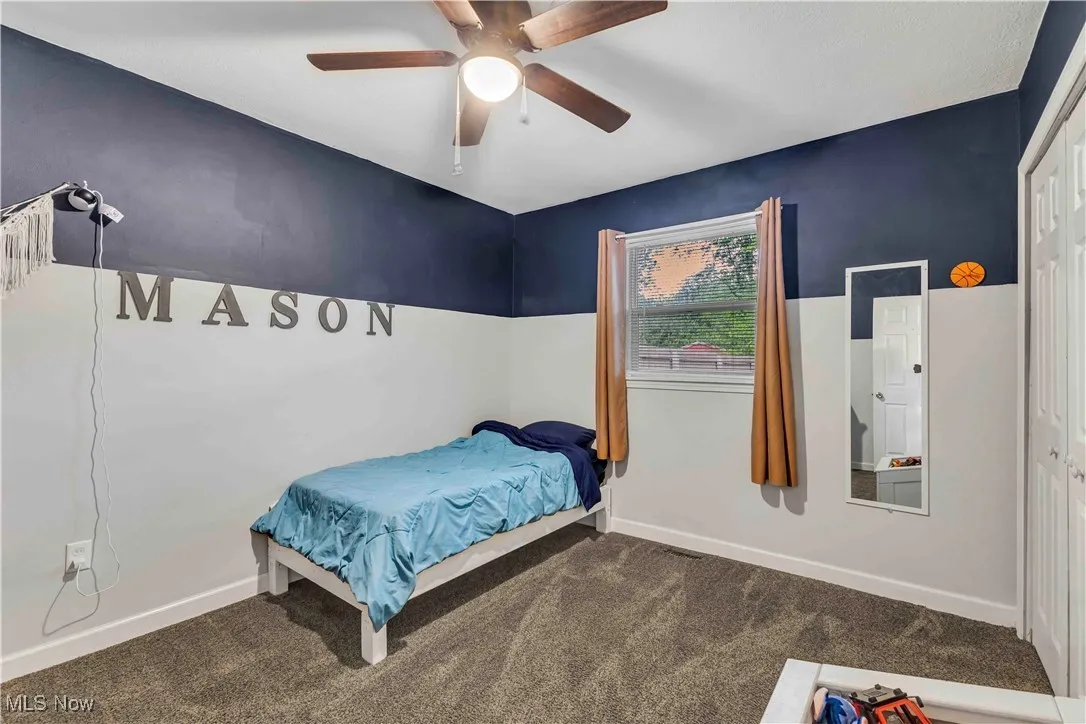 Bedroom featuring carpet floors, a ceiling fan, and a closet.