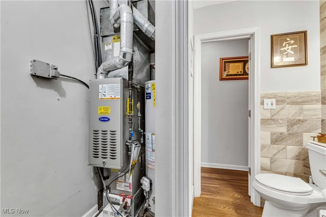 Utility room featuring furnace and water heater