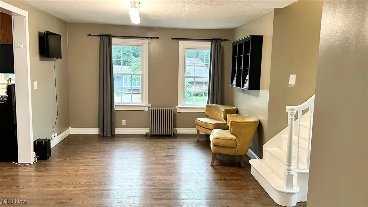 Dining room with wood floors,and a textured ceiling