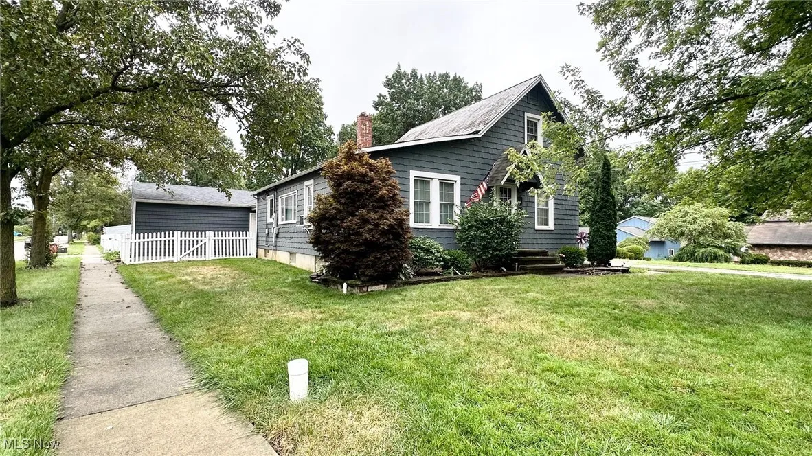 View of side of property featuring a chimney