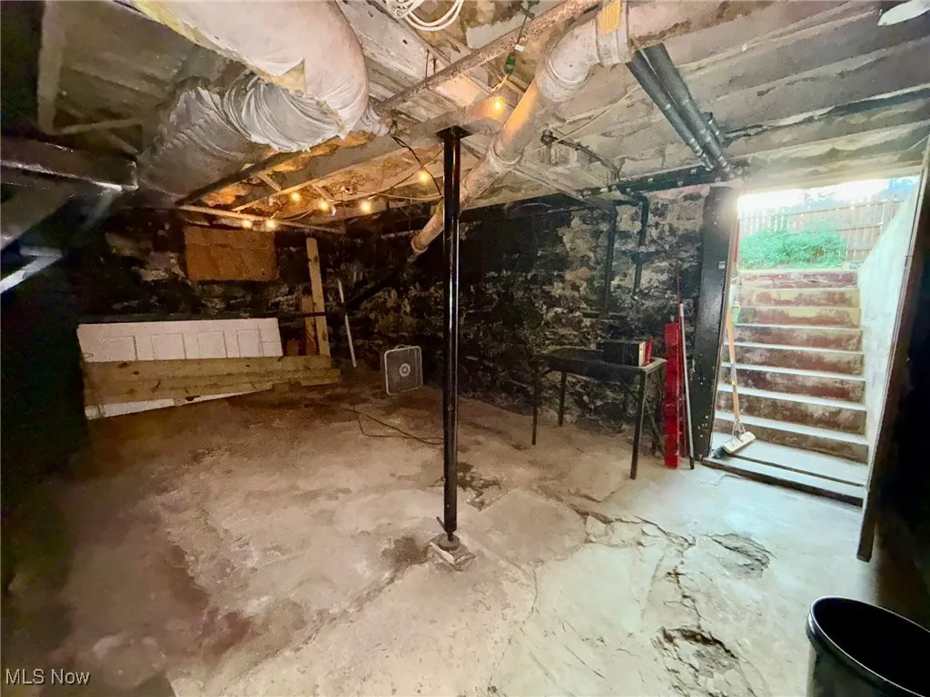 Unfinished basement featuring stairway