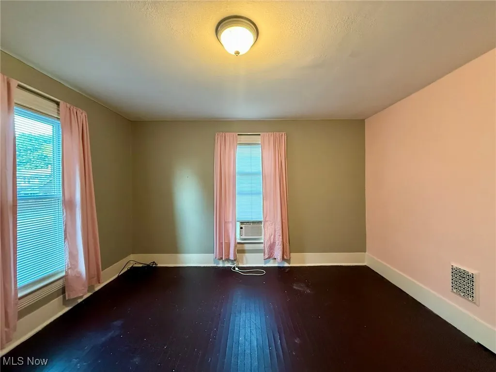Bedroom with hardwood / wood-style flooring and baseboards