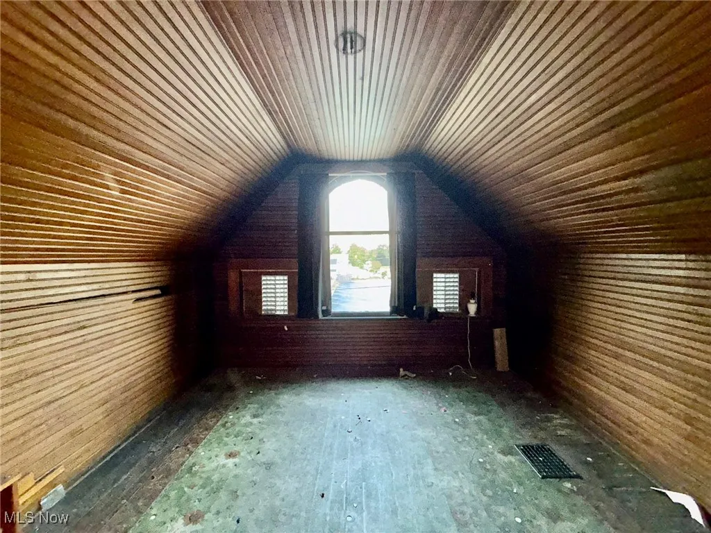 Bonus room in attic featuring lofted ceiling and wooden ceiling