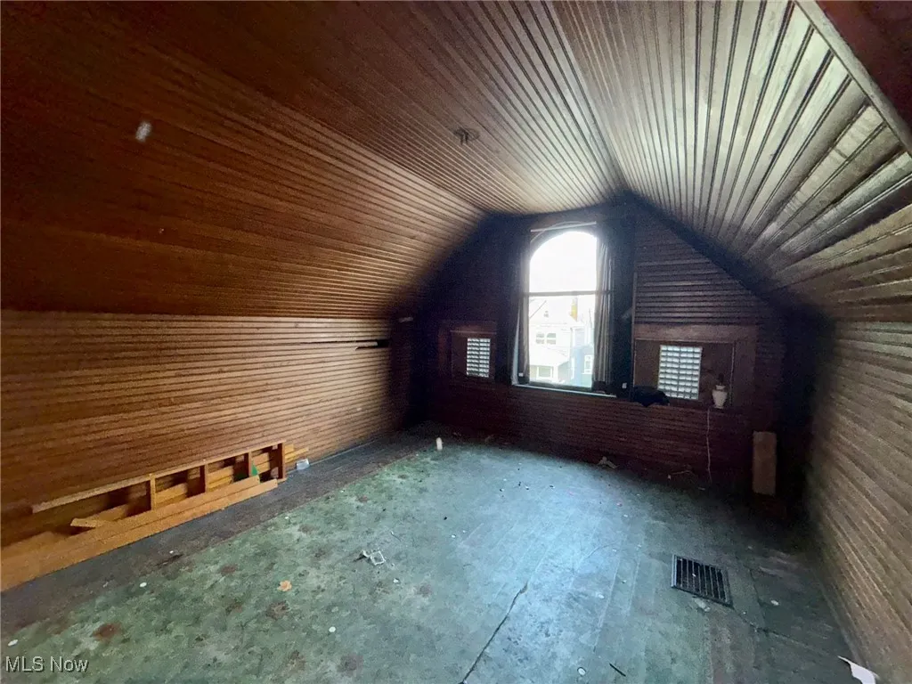 Bonus room in attic featuring lofting ceiling and wooden ceiling