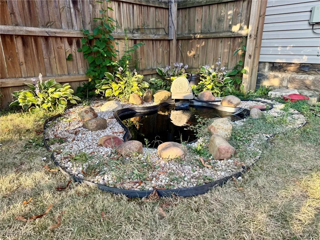 View of yard with a garden pond