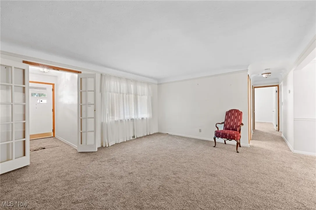 Unfurnished room with carpet flooring and baseboards