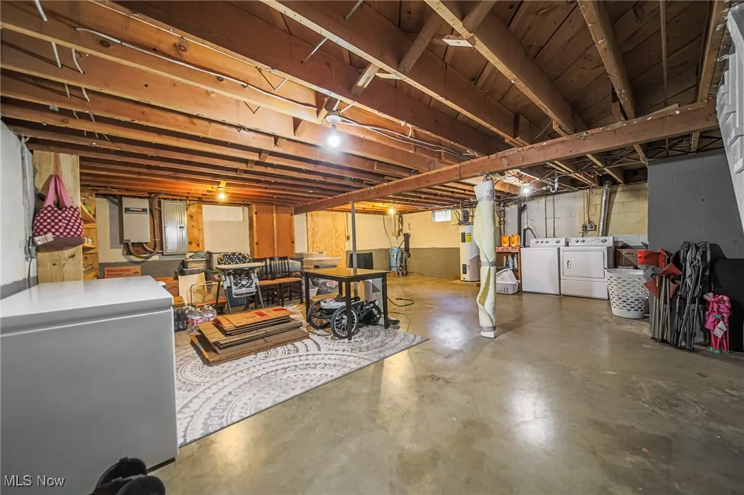 Unfinished basement featuring independent washer and dryer
