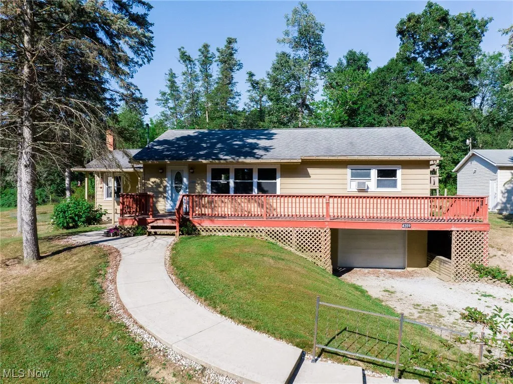 View of front of property with a front yard and a garage