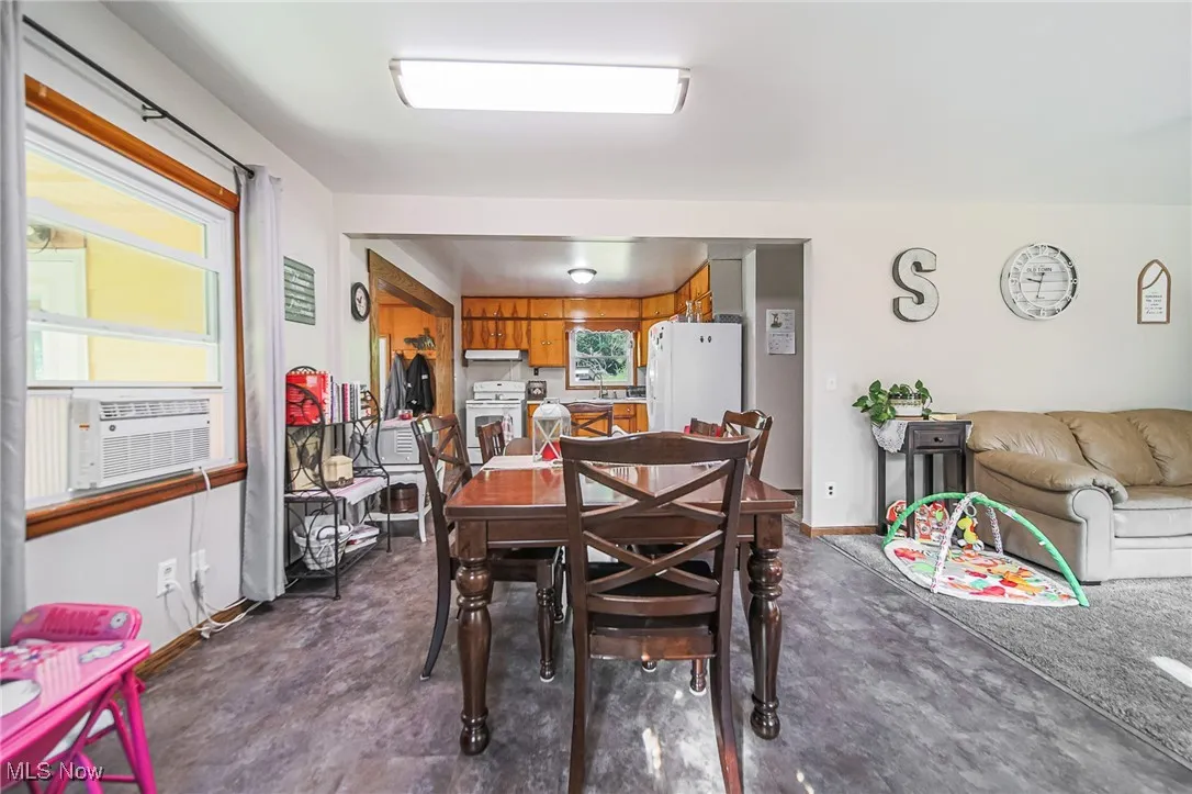 Dining room featuring baseboards and cooling unit