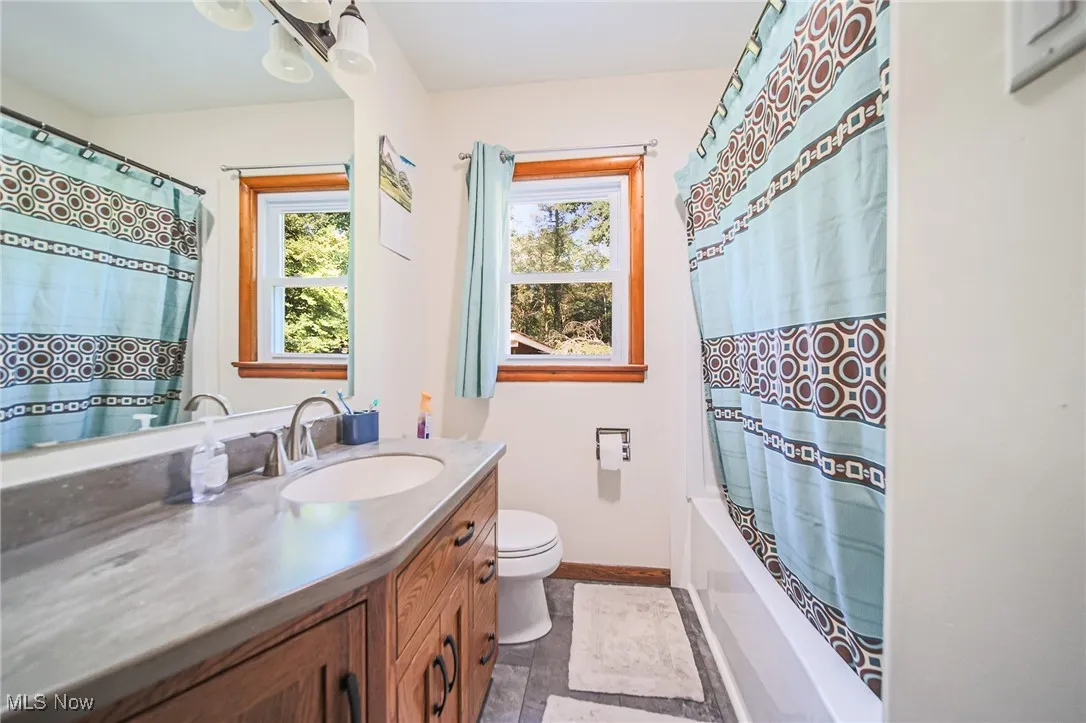 Full bathroom featuring vanity and shower / tub combo with curtain