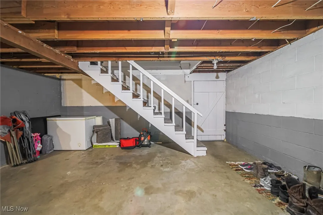 Unfinished below grade area featuring stairs