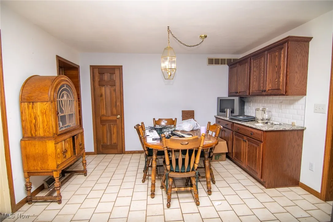 Dining room with baseboards and a chandelier