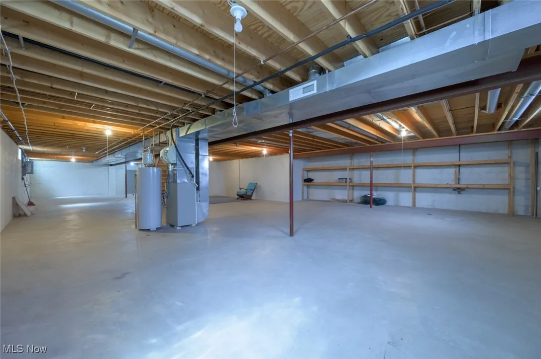 Unfinished basement with heating unit and gas water heater