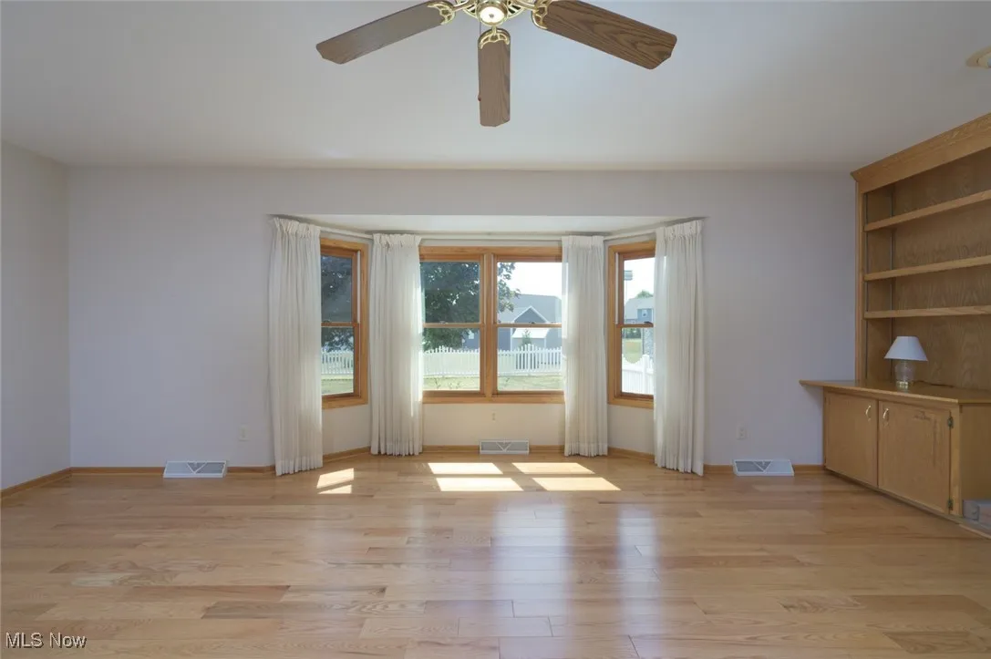 Spare room featuring light wood-type flooring and a ceiling fan
