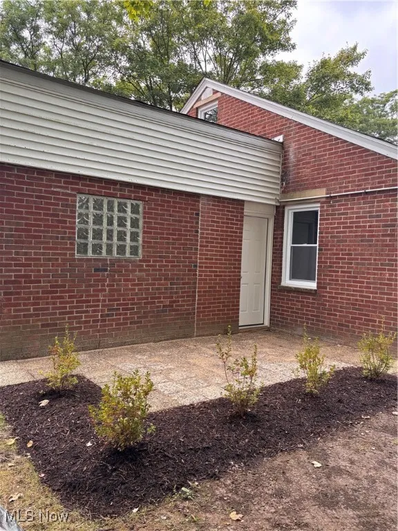 Rear view of house with brick siding