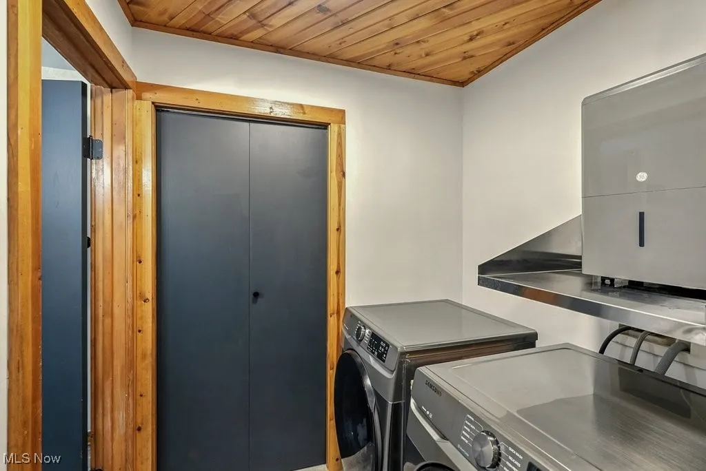 Washroom featuring wooden ceiling and separate washer and dryer