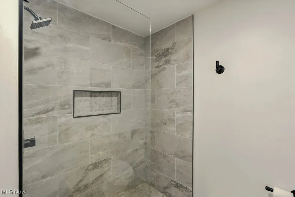 Full bathroom with a shower stall