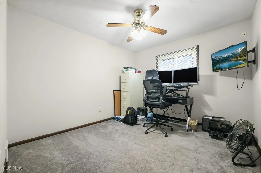 Office space with carpet flooring and ceiling fan