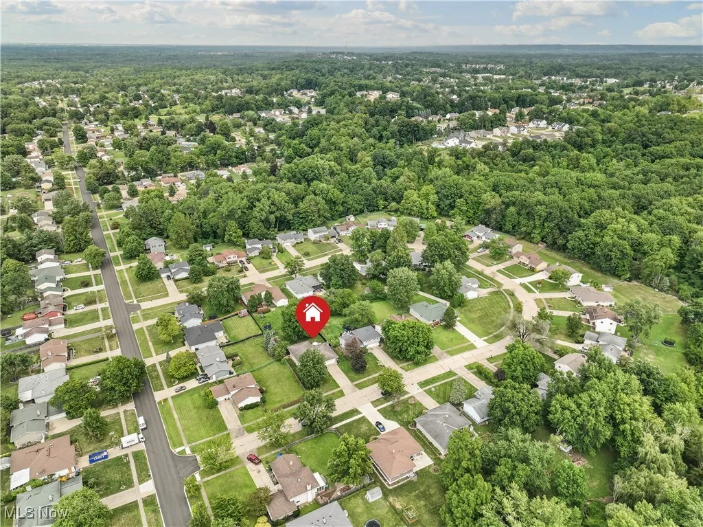 Aerial view of residential area featuring a heavily wooded area