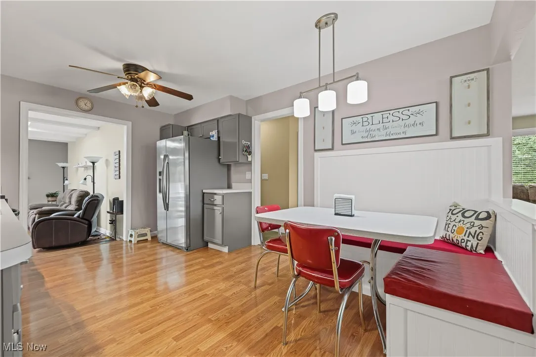 Dining area with light wood finished floors and ceiling fan