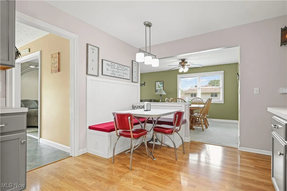 Dining area with light wood-style floors and a ceiling fan