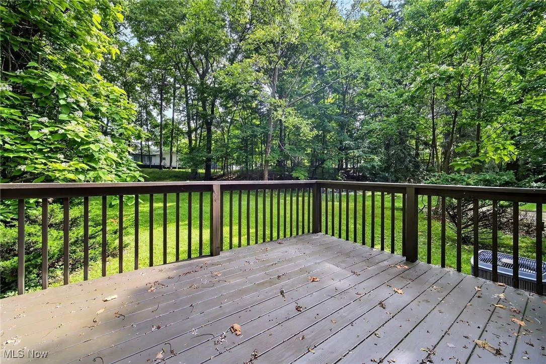 Wooden deck featuring a lawn