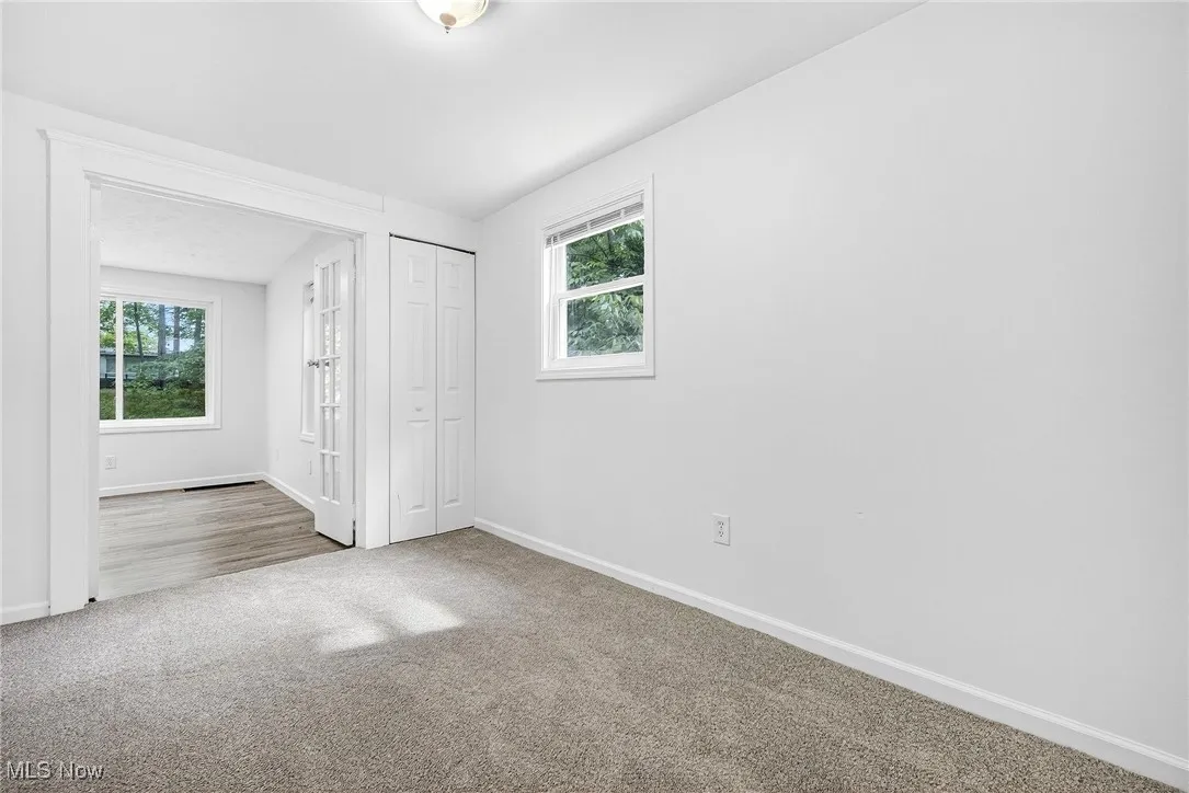 Unfurnished bedroom with carpet and a closet