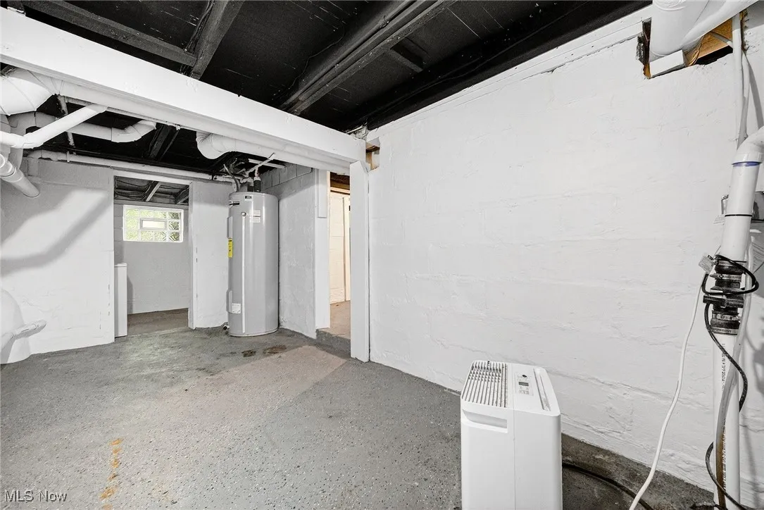 Below grade area featuring water heater