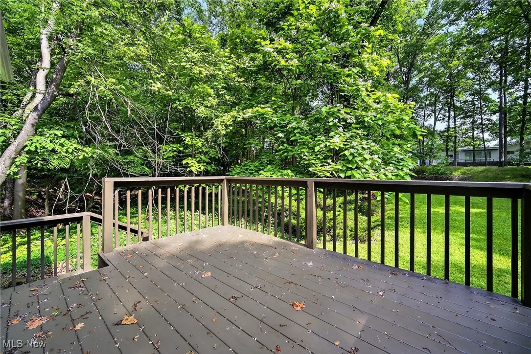 Wooden deck featuring a lawn