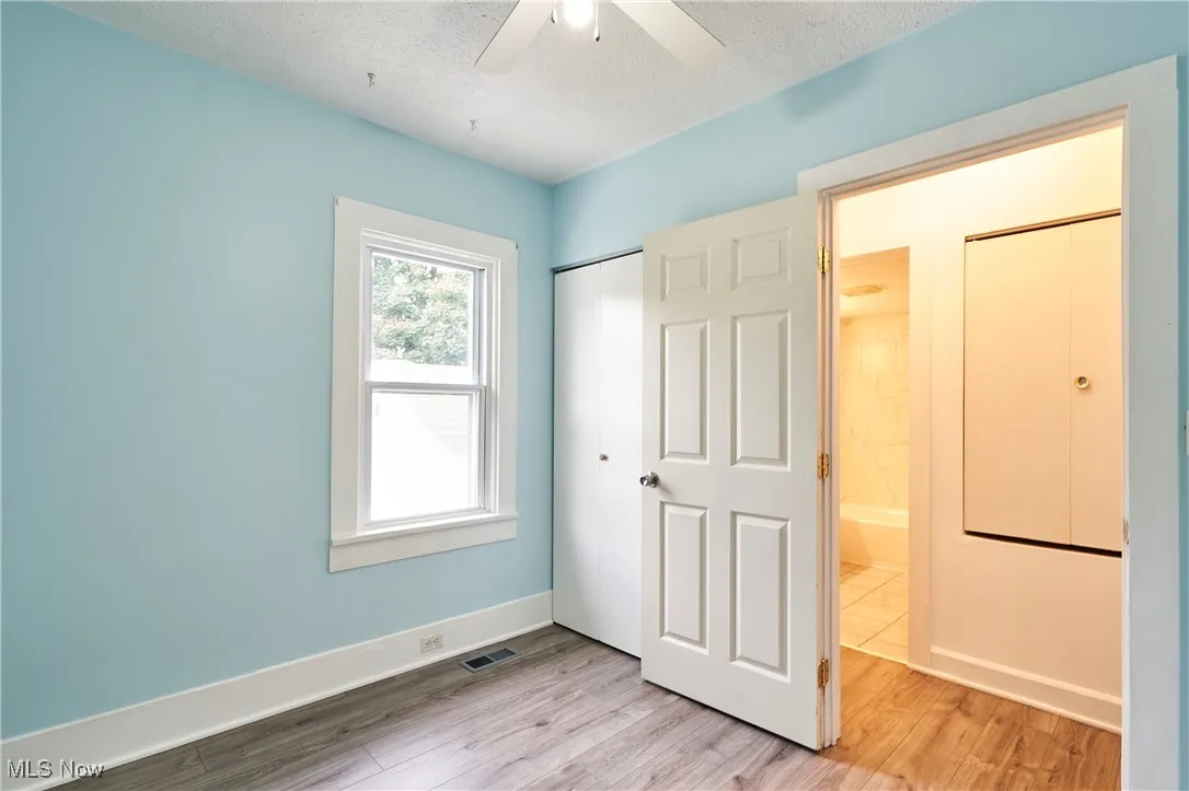 Bedroom with Fresh paint,LVT flooring and new ceiling fan