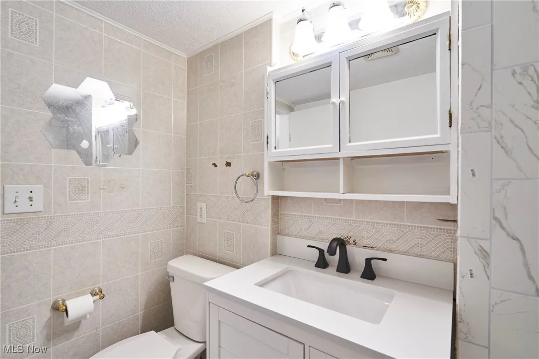 New medicine cabinet, lighting, sink, and  faucet