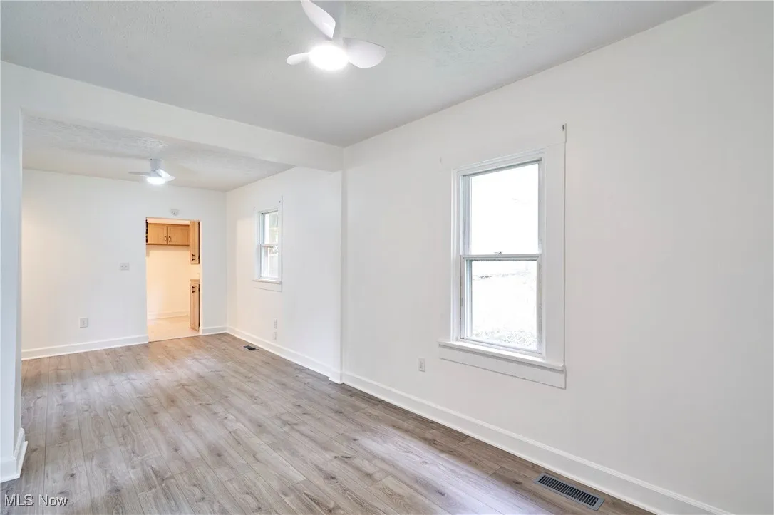 Living room and dining with fresh paint, new LVT and ceiling fans