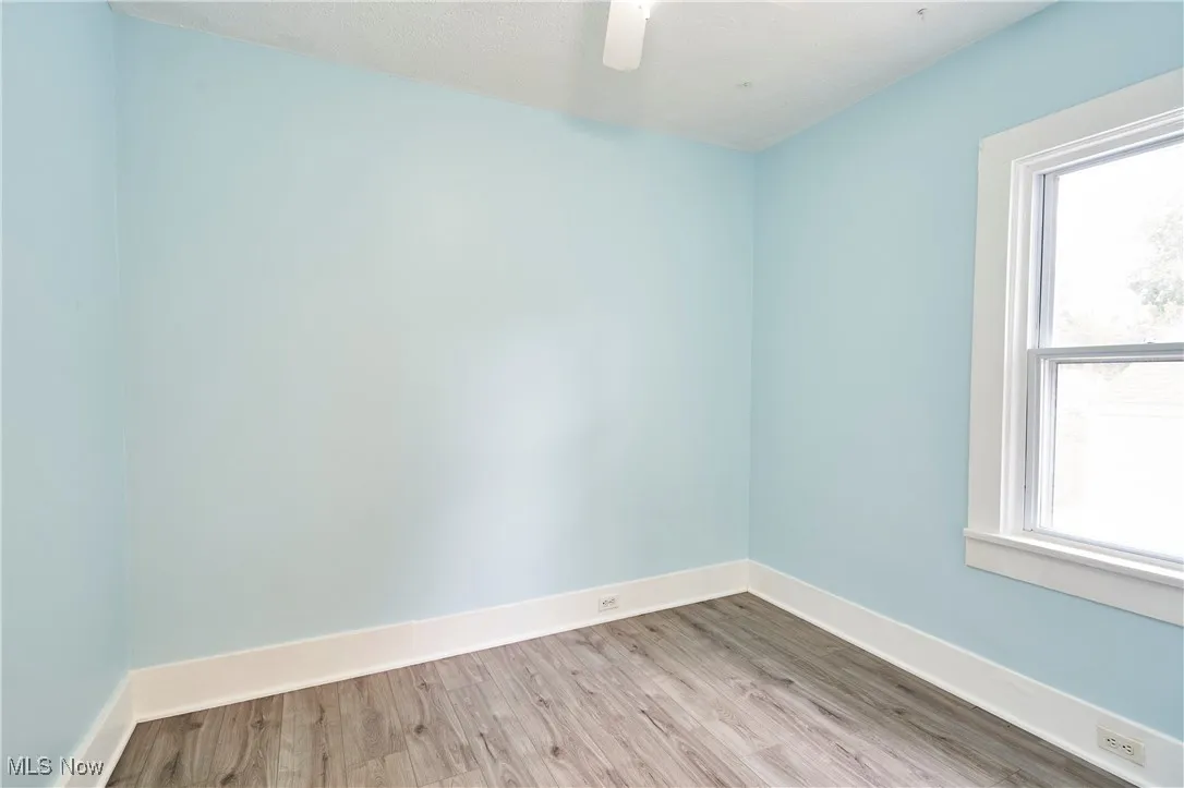 Bedroom with Fresh paint,LVT flooring and new ceiling fan