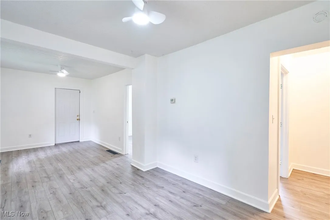 Living room and dining with fresh paint, new LVT and ceiling fans