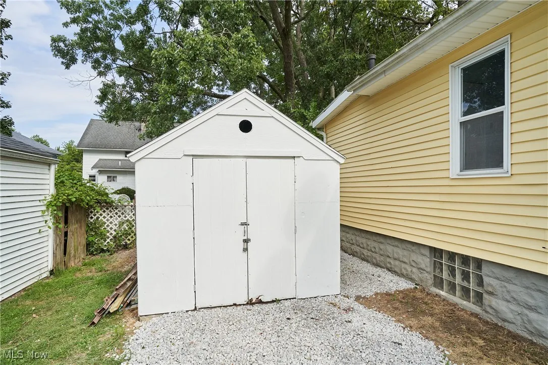 View of shed and new gravel in the driveway