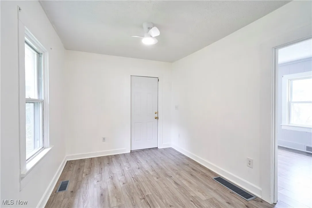 Bedroom 1 with new LTV flooring , paint and ceiling fan