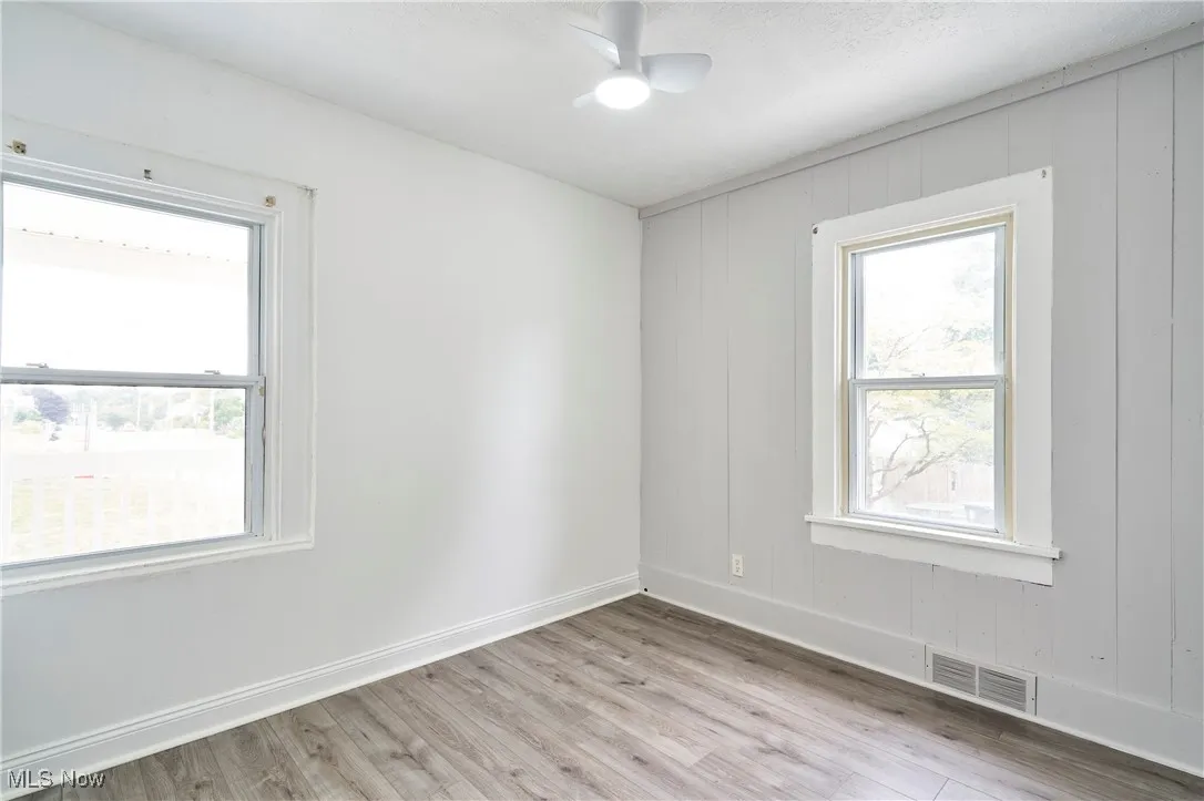 Bedroom 1 with Fresh paint,LVT flooring and new ceiling fan