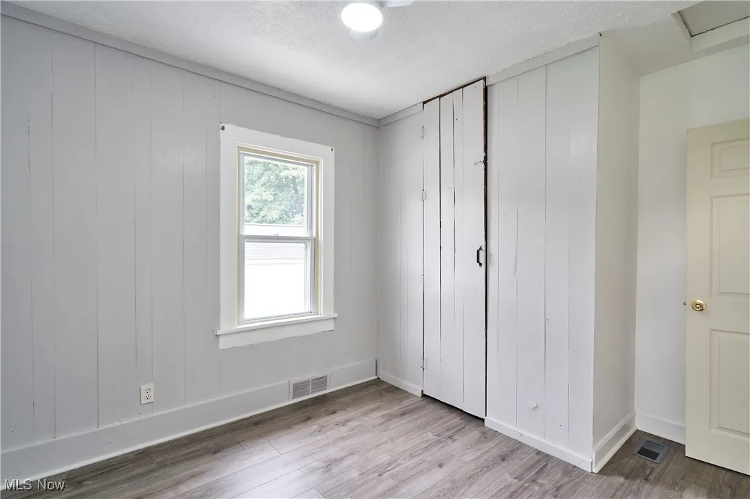 Bedroom 1 with Fresh paint,LVT flooring and new ceiling fan