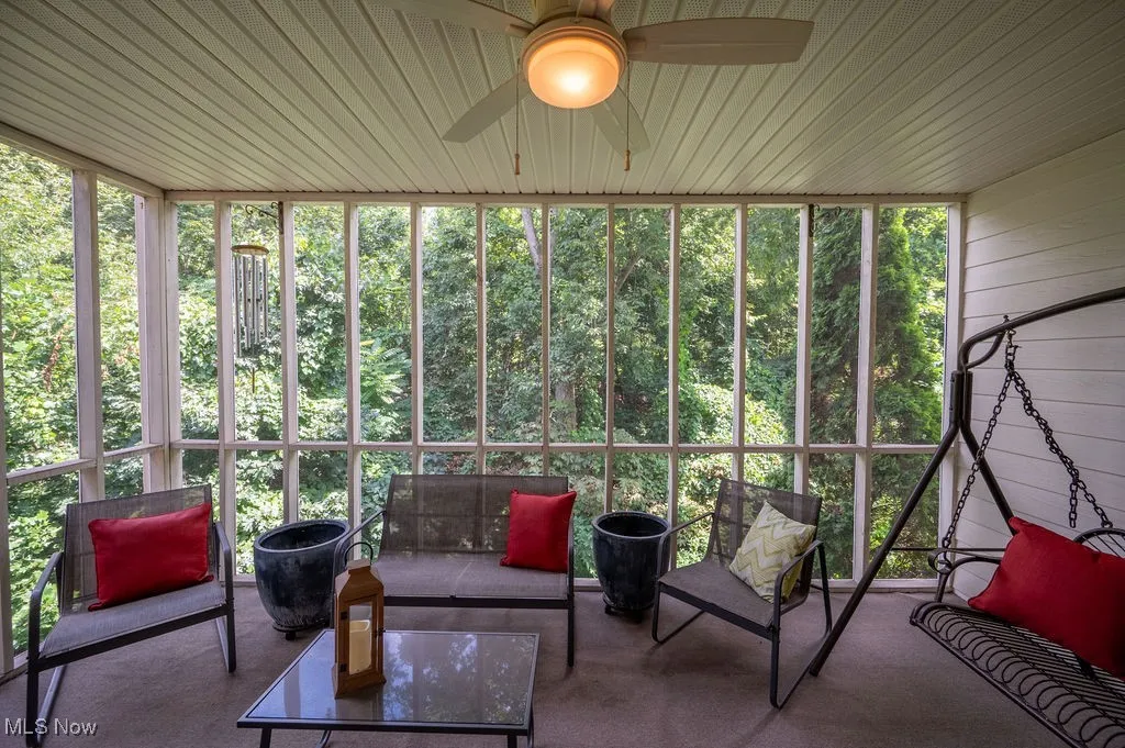 Sunroom / solarium with an outdoor living space and ceiling fan